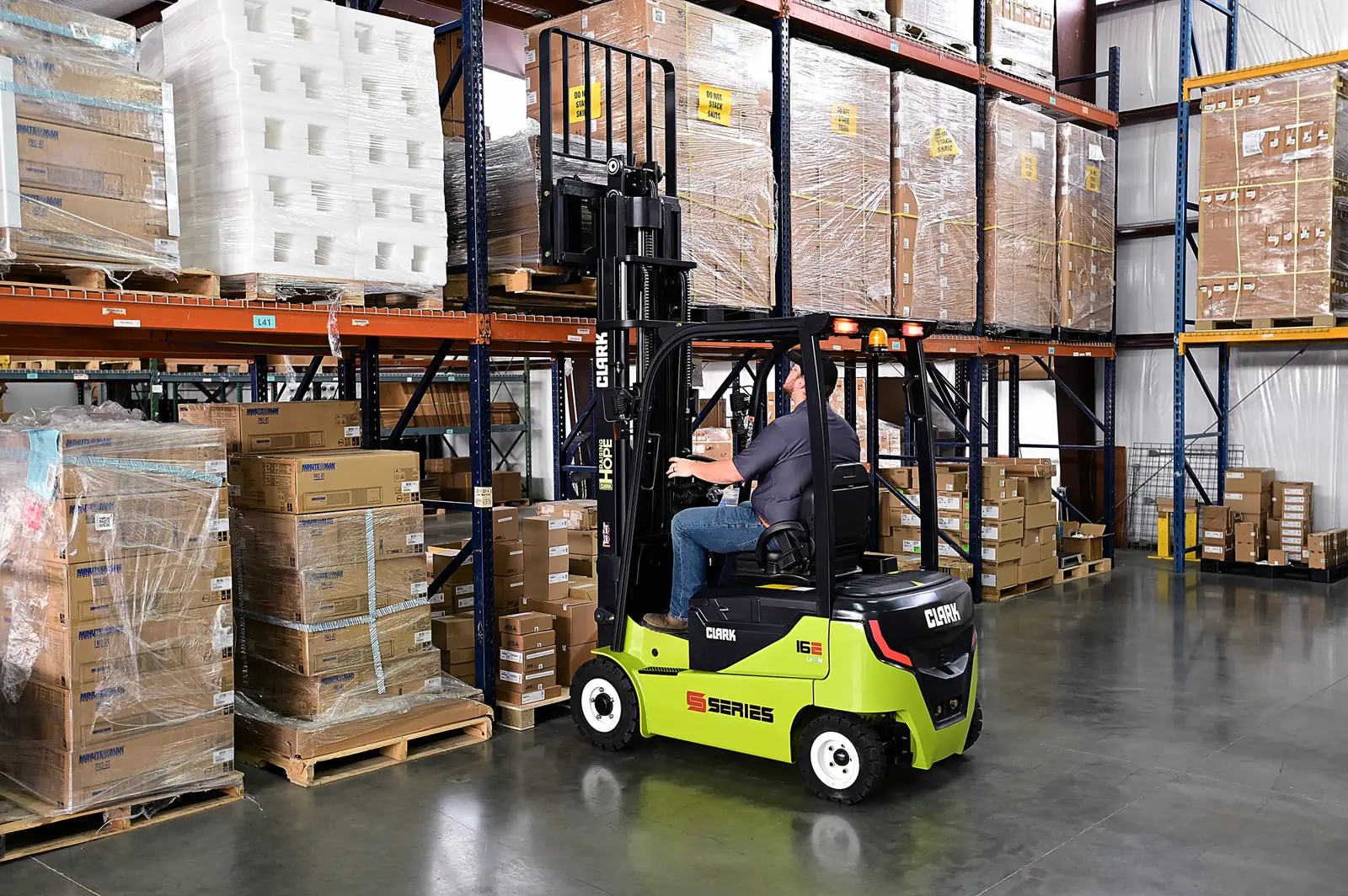 Operator running a forklift in front of pallet racking in a Richmond VA warehouse